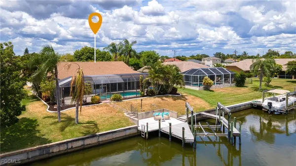 a swimming pool with outdoor seating and yard