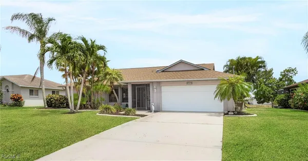 a front view of a house with a garden and yard