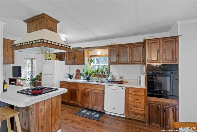 a kitchen with a sink stove and cabinets