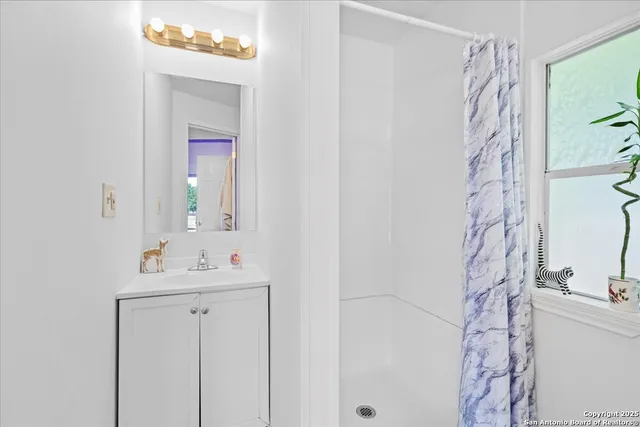 a view of a patio with table and chairs potted plants with wooden floor and fence