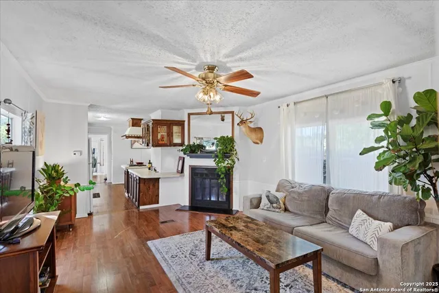 a living room with furniture a flat screen tv and a potted plant