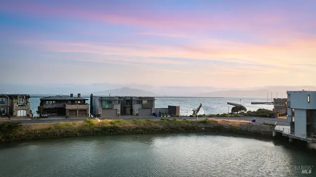a view of a lake with cars parked