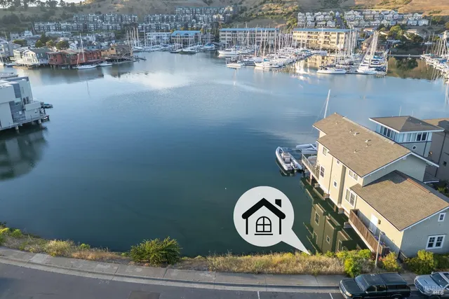 an aerial view of a house with swimming pool and ocean view