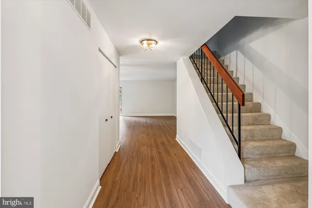 a view of entryway and hall with wooden floor
