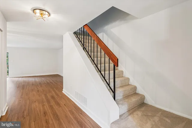 a view of a kitchen with sink and dishwasher with wooden floor