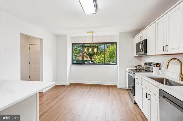 a kitchen with stainless steel appliances a refrigerator sink and stove