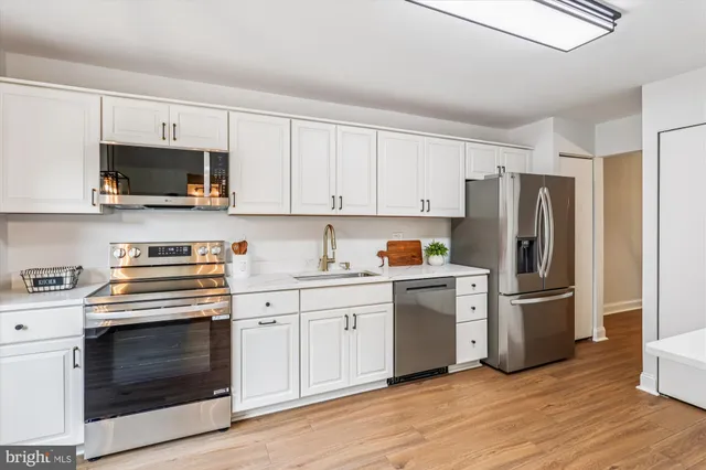 a kitchen with stainless steel appliances a refrigerator and a sink