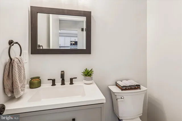 a bathroom with a sink mirror and vanity