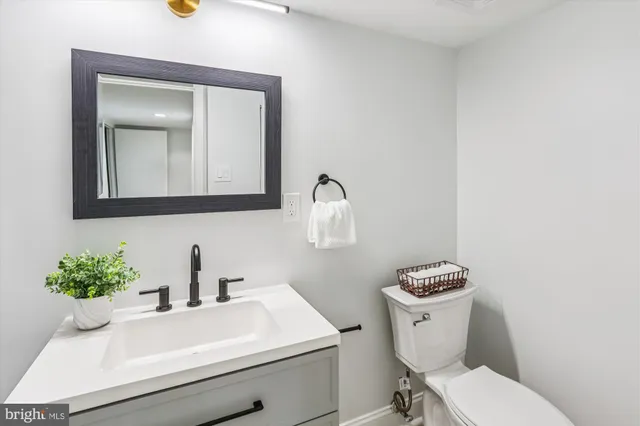 a view of a house with a patio and wooden fence
