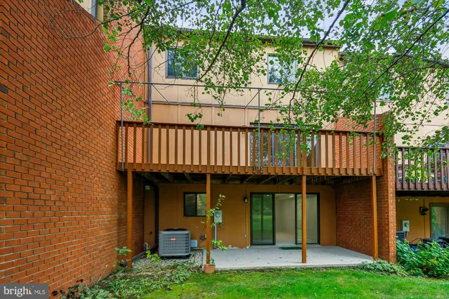 a view of a balcony with wooden floor and fence