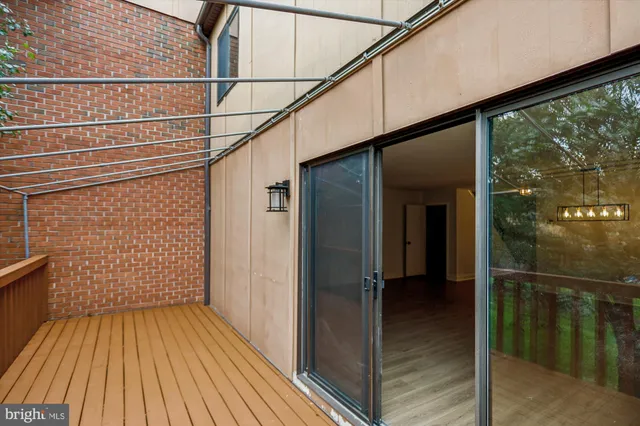 a view of a balcony with wooden floor and fence
