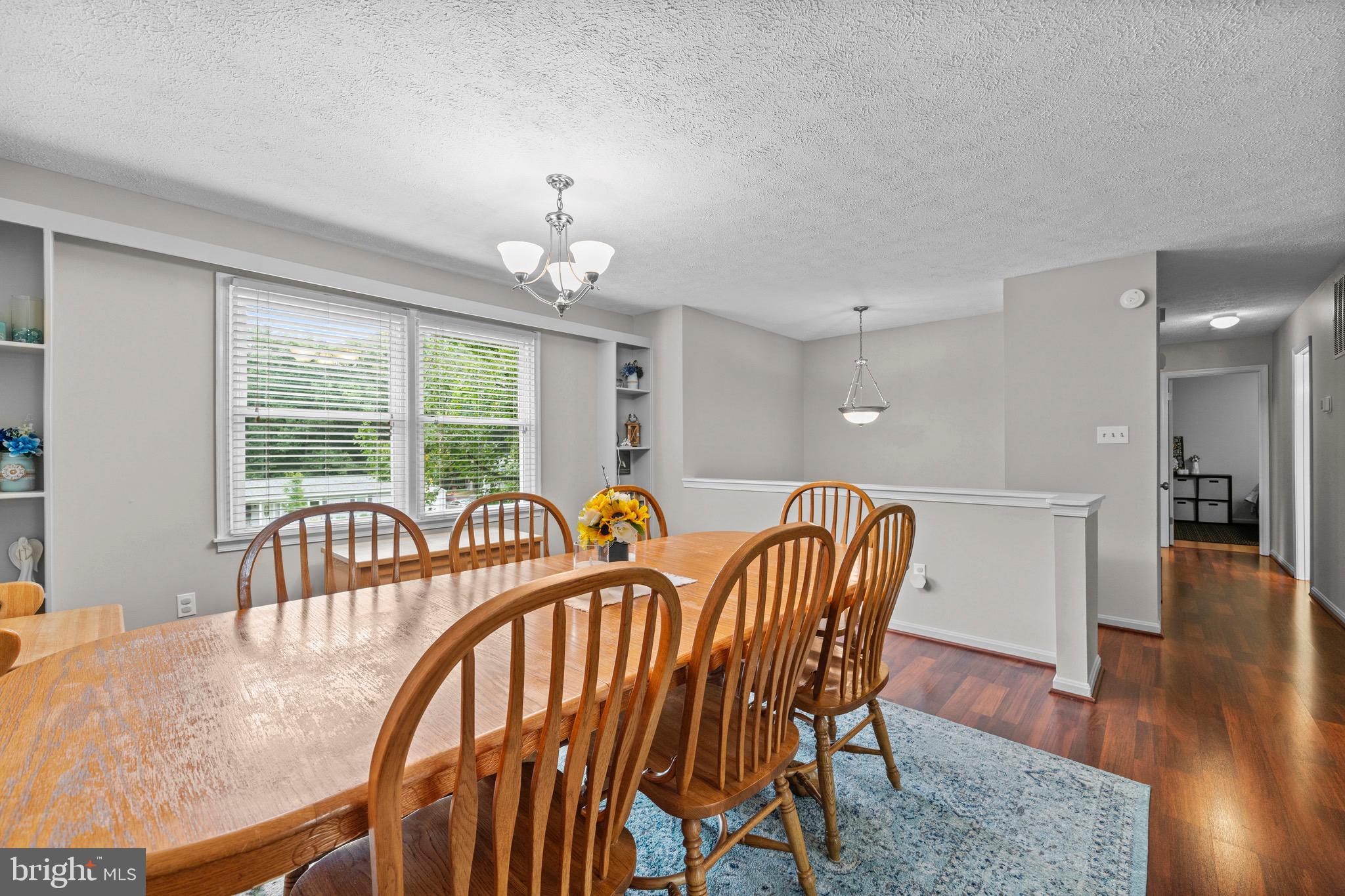 26599 Yowaiski Mill Road Mechanicsville, MD 20659 - Photo 14 of 58 a view of a dining room with furniture wooden floor and chandelier