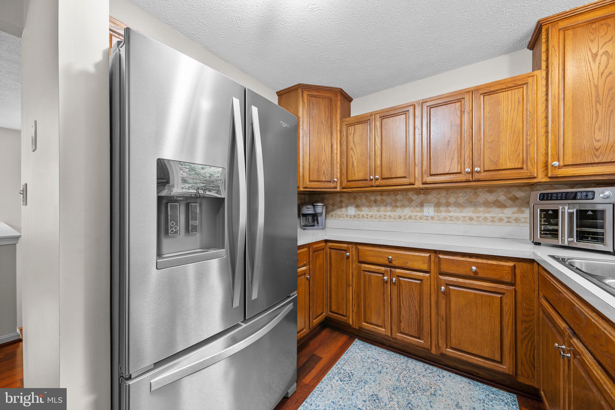 26599 Yowaiski Mill Road Mechanicsville, MD 20659 - Photo 21 of 58 a kitchen with stainless steel appliances granite countertop a refrigerator and cabinets