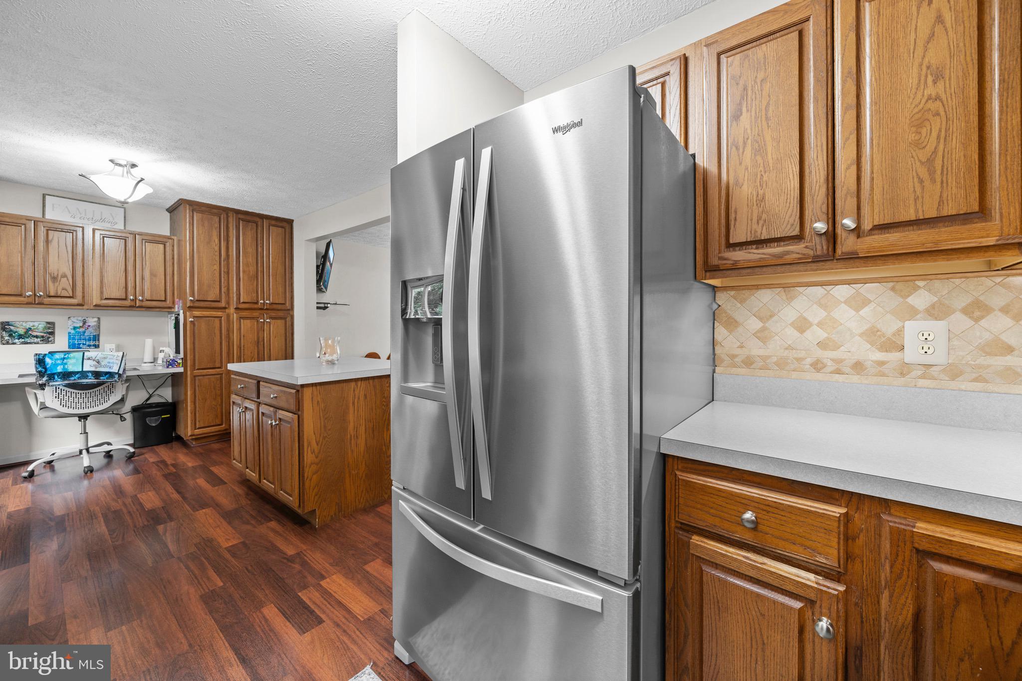 26599 Yowaiski Mill Road Mechanicsville, MD 20659 - Photo 22 of 58 a kitchen with stainless steel appliances granite countertop a refrigerator and a stove top oven