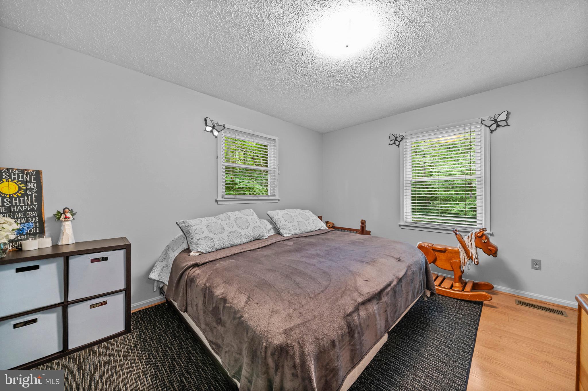 26599 Yowaiski Mill Road Mechanicsville, MD 20659 - Photo 26 of 58 a bed sitting in a bedroom next to a window