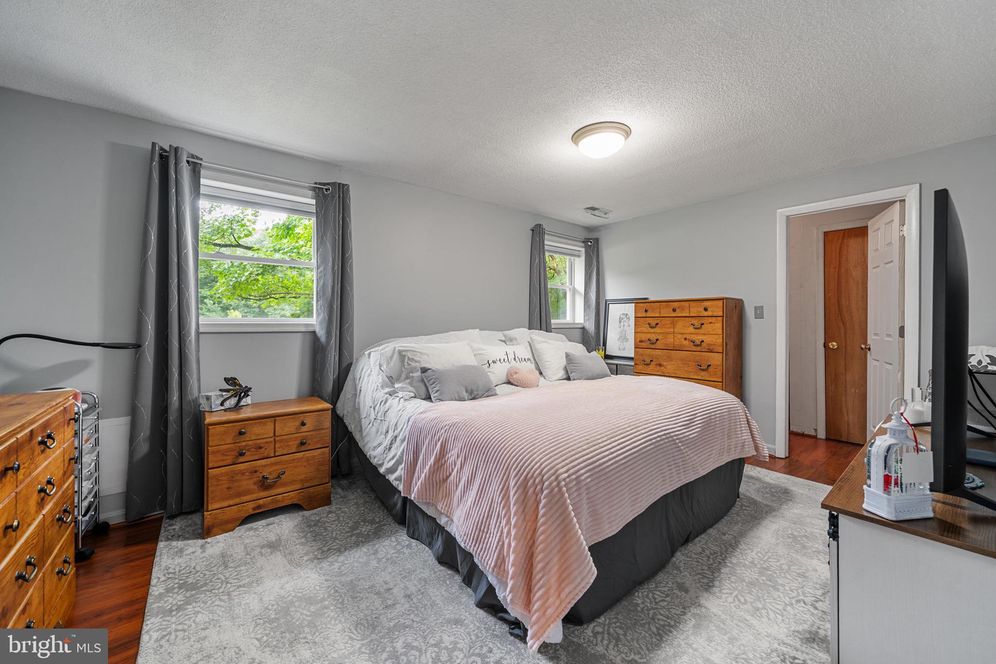 26599 Yowaiski Mill Road Mechanicsville, MD 20659 - Photo 32 of 58 a bedroom with a bed and flat tv screen on the dresser