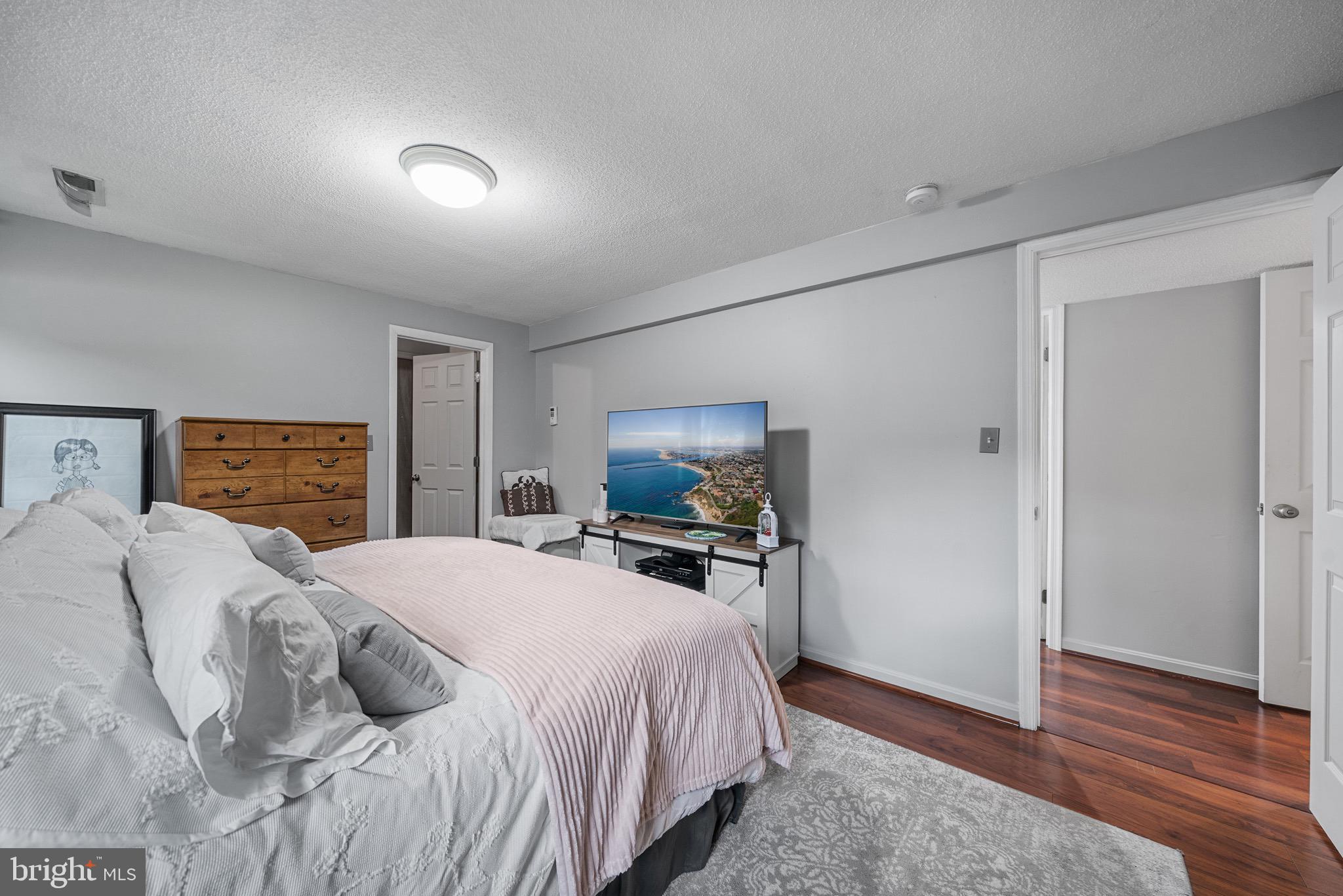 26599 Yowaiski Mill Road Mechanicsville, MD 20659 - Photo 34 of 58 a bedroom with a bed and wooden floor