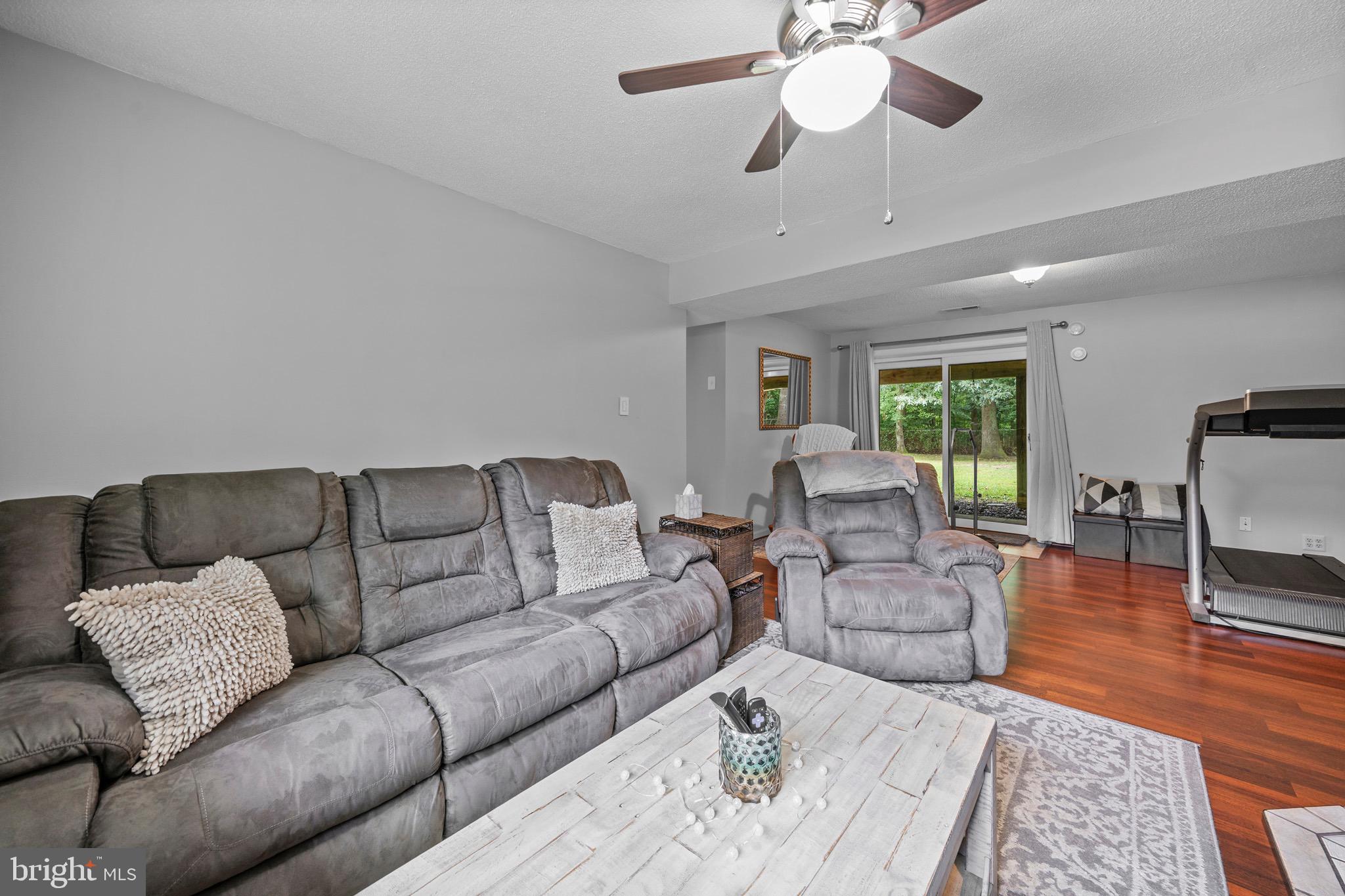 26599 Yowaiski Mill Road Mechanicsville, MD 20659 - Photo 35 of 58 a living room with furniture and a large window