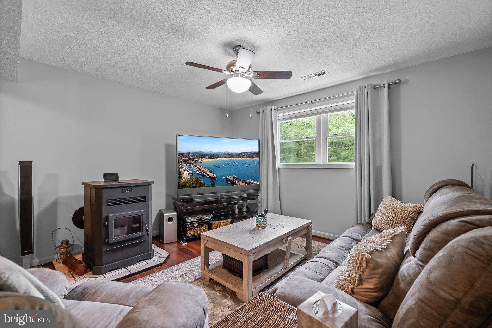 26599 Yowaiski Mill Road Mechanicsville, MD 20659 - Photo 38 of 58 a living room with furniture a flat screen tv and a window