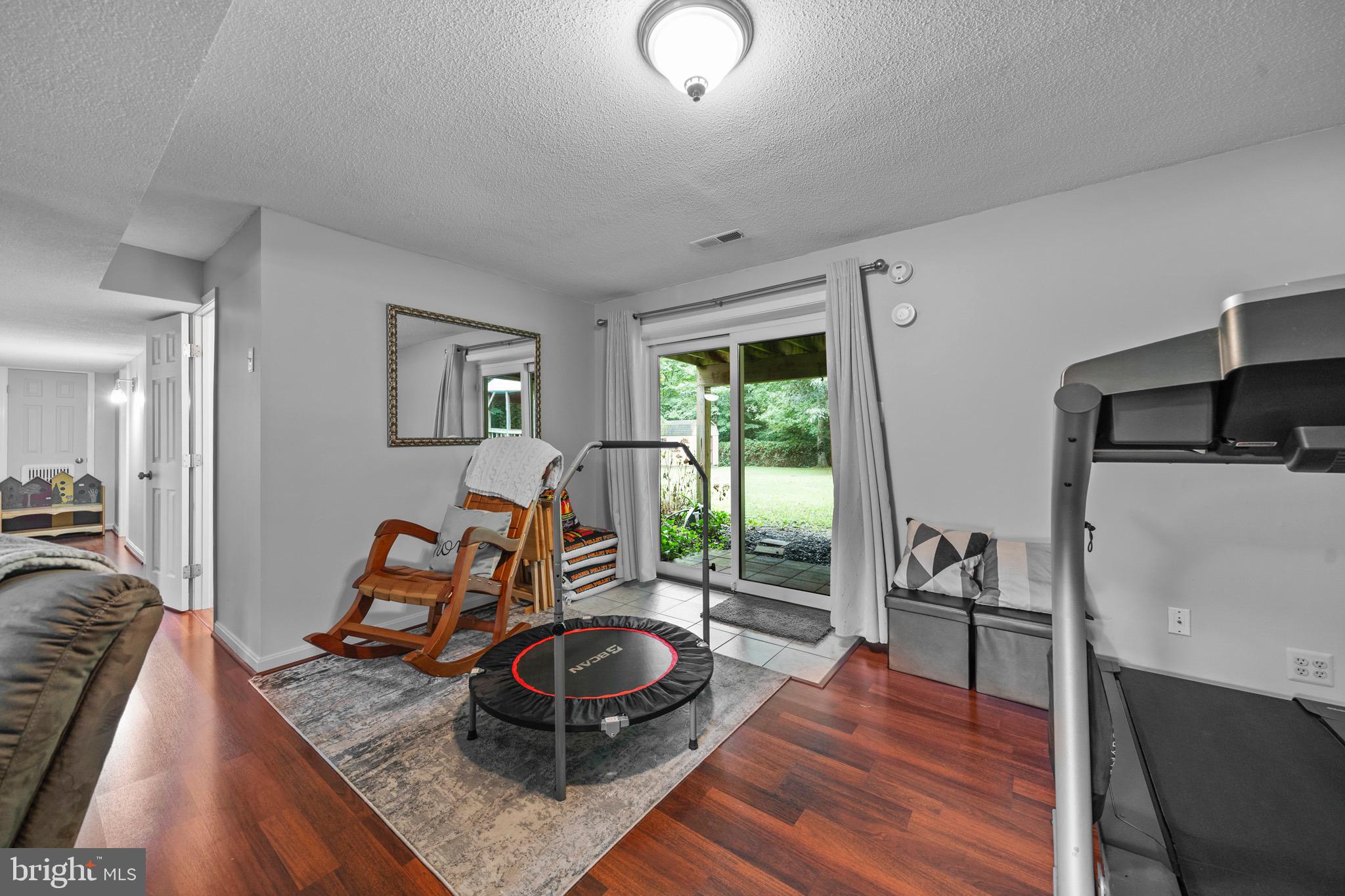 26599 Yowaiski Mill Road Mechanicsville, MD 20659 - Photo 39 of 58 a room with furniture and a wooden floor