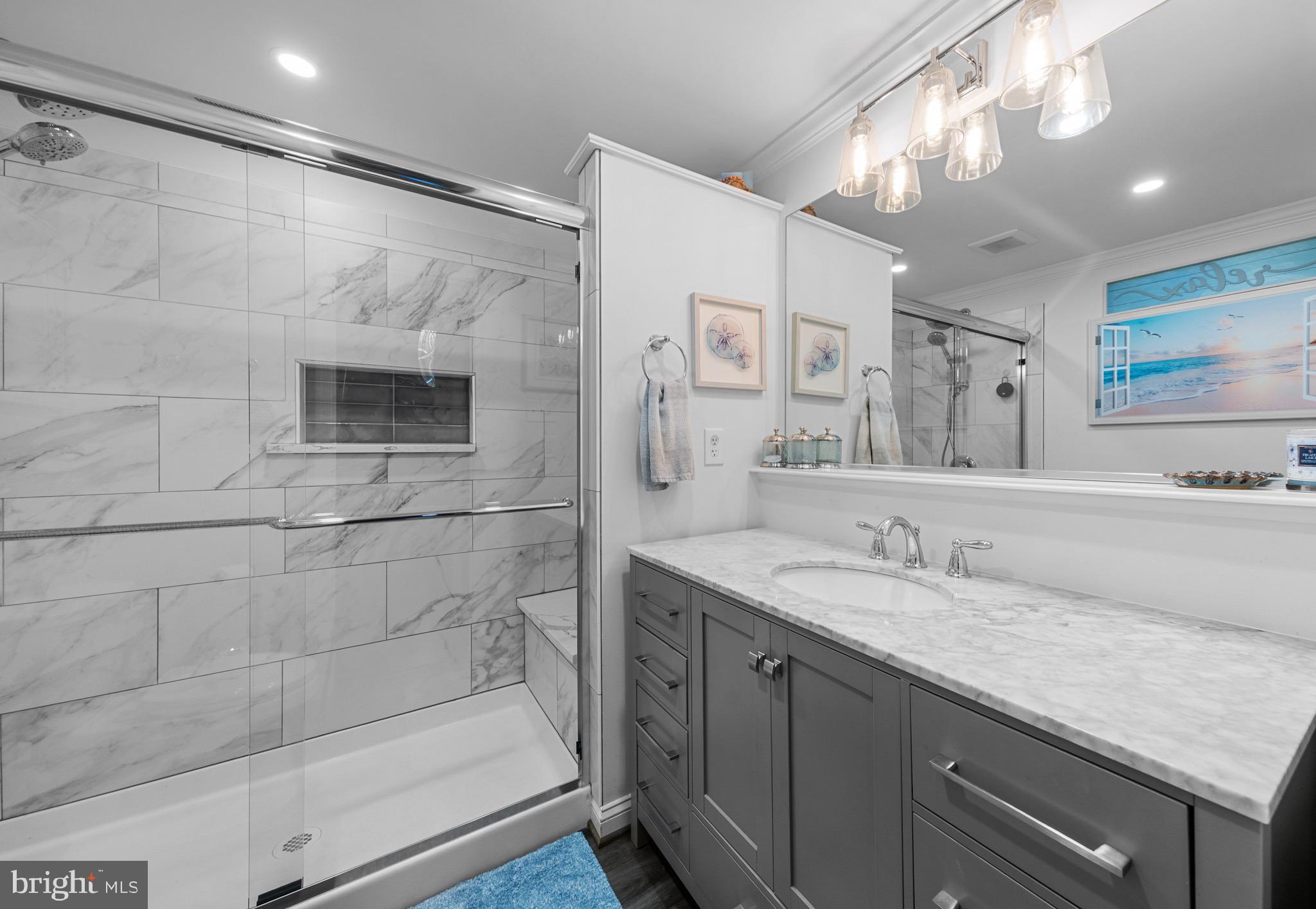26599 Yowaiski Mill Road Mechanicsville, MD 20659 - Photo 40 of 58 a bathroom with a granite countertop sink a mirror and shower