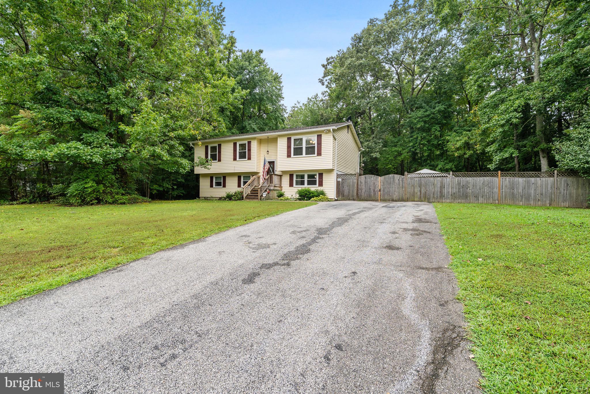 26599 Yowaiski Mill Road Mechanicsville, MD 20659 - Photo 4 of 58 a front view of a house with yard and green space