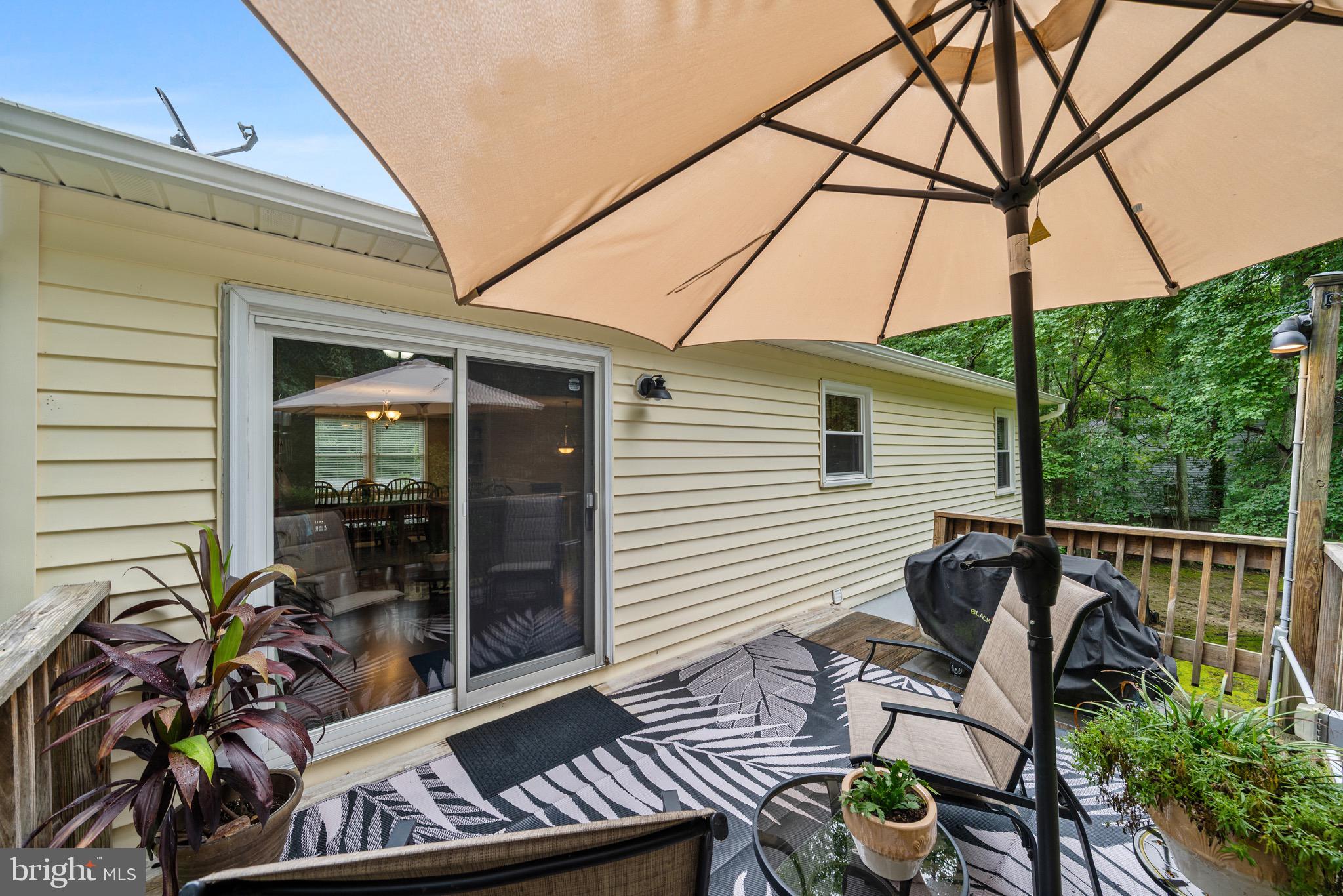 26599 Yowaiski Mill Road Mechanicsville, MD 20659 - Photo 9 of 58 a patio with table and chairs and potted plants