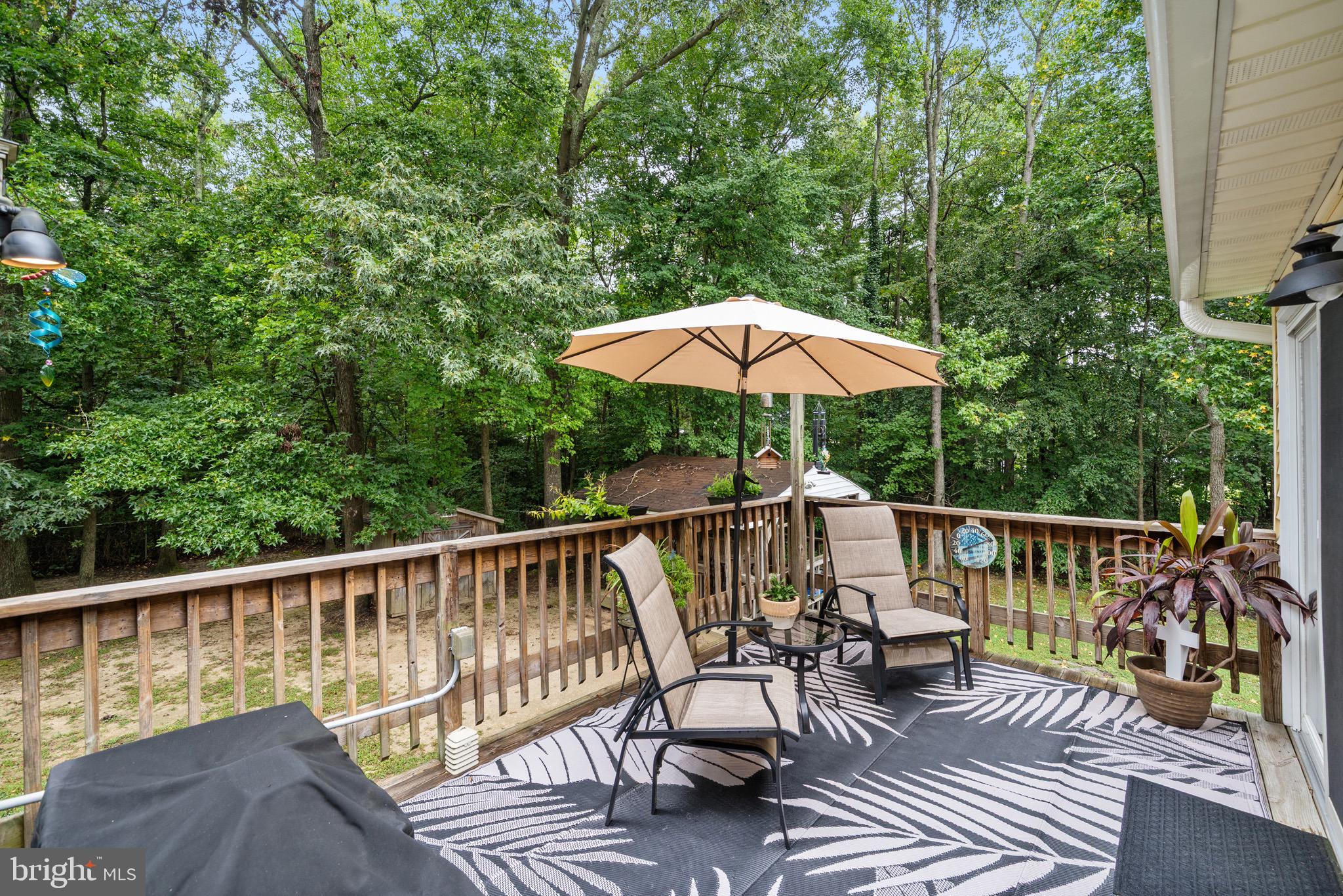 26599 Yowaiski Mill Road Mechanicsville, MD 20659 - Photo 10 of 58 a view of balcony with outdoor seating and trees