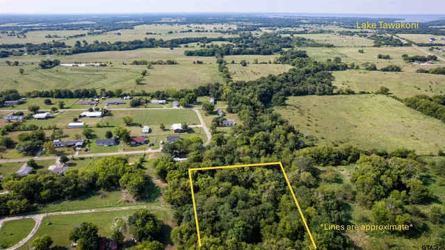 an aerial view of a houses with a yard