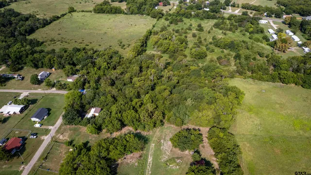 an aerial view of a houses with a yard