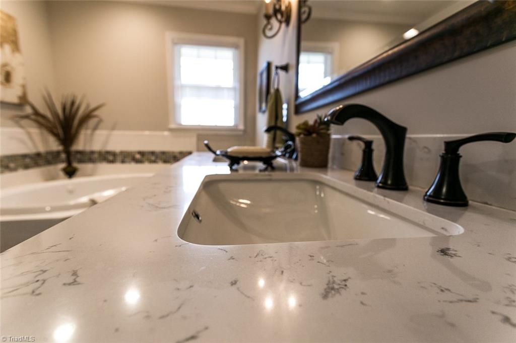 264 Welcome View Church Road Dobson, NC 27017 - Photo 12 of 30 Solid surface counter tops in bath with double sinks.