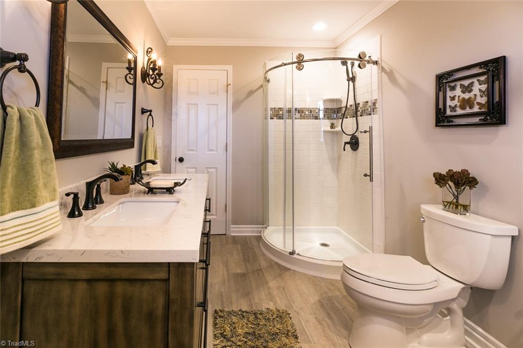 264 Welcome View Church Road Dobson, NC 27017 - Photo 13 of 30 Hall bath also features walk-in shower with glass surround.