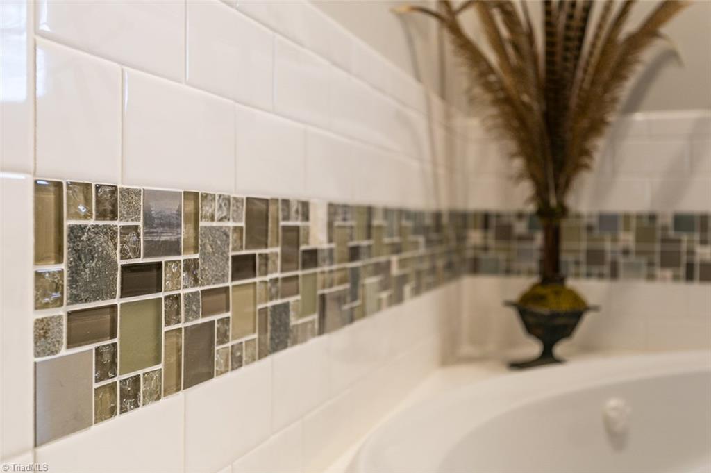 264 Welcome View Church Road Dobson, NC 27017 - Photo 14 of 30 Mosaic tile accents can be found in tub and shower surround.