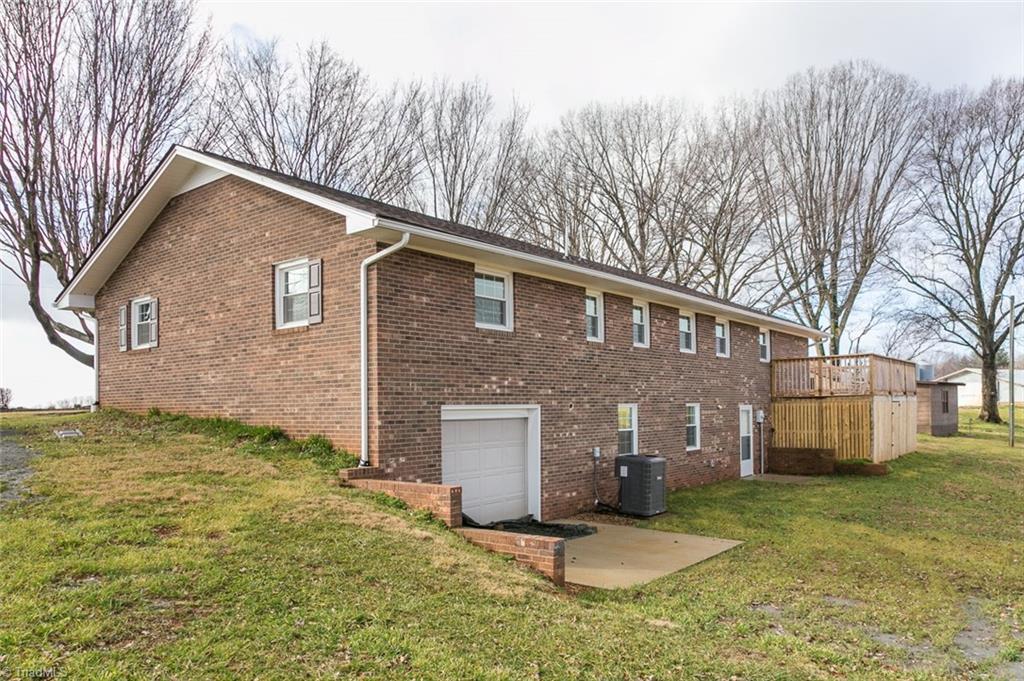 264 Welcome View Church Road Dobson, NC 27017 - Photo 24 of 30 Side/rear view of home with garage door basement and cement pad.