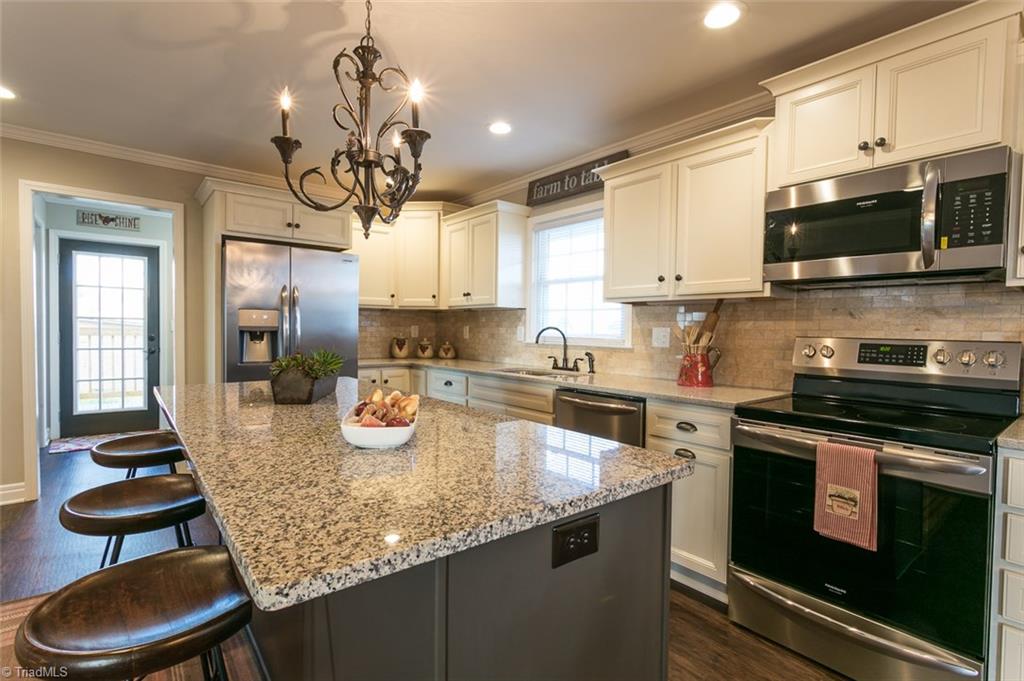 264 Welcome View Church Road Dobson, NC 27017 - Photo 6 of 30 Generous kitchen features granite counter tops, Diamond easy-close cabinetry, stainless steel appliances, large eat-in island.