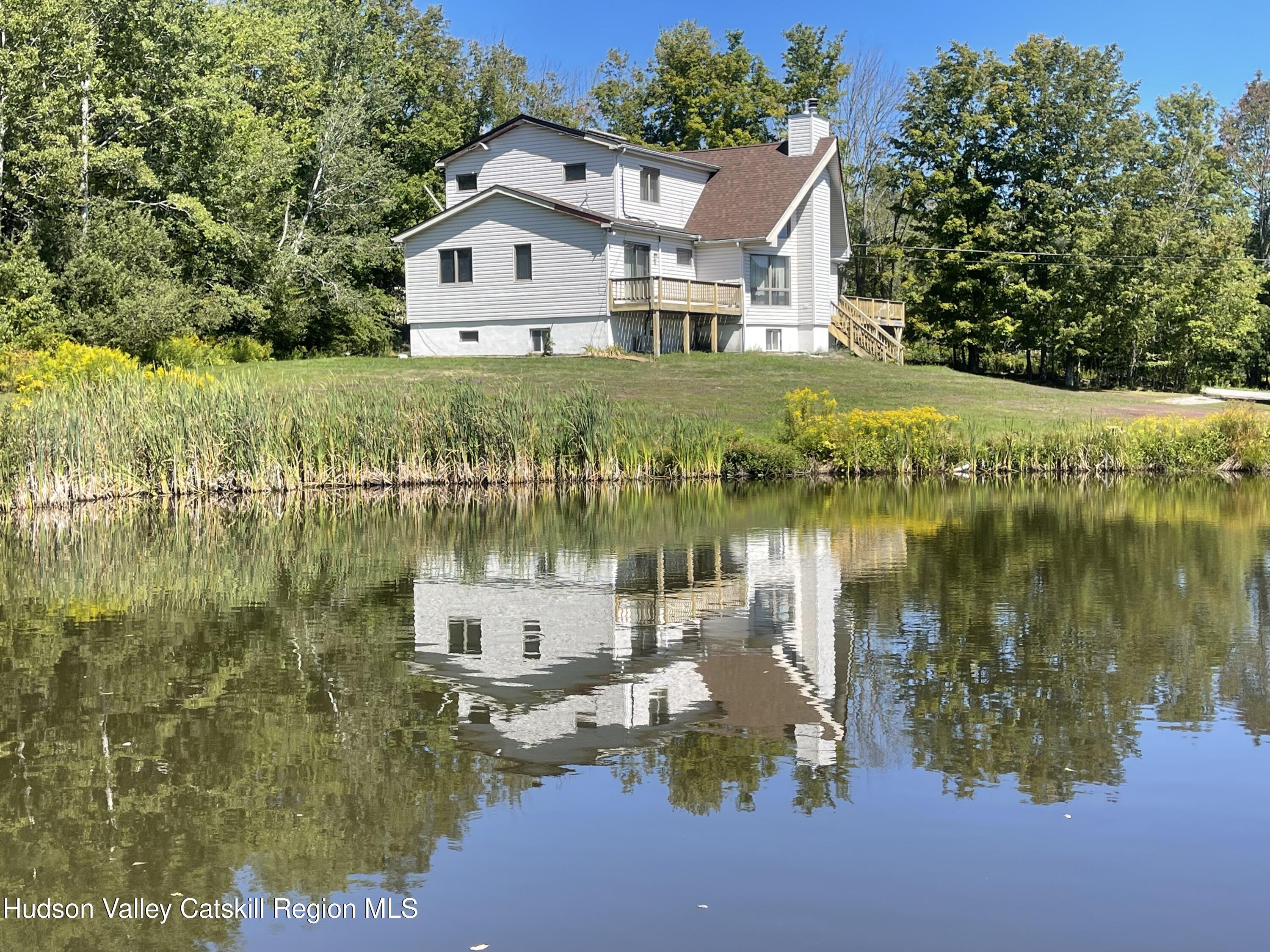 a view of a lake with a house in the background