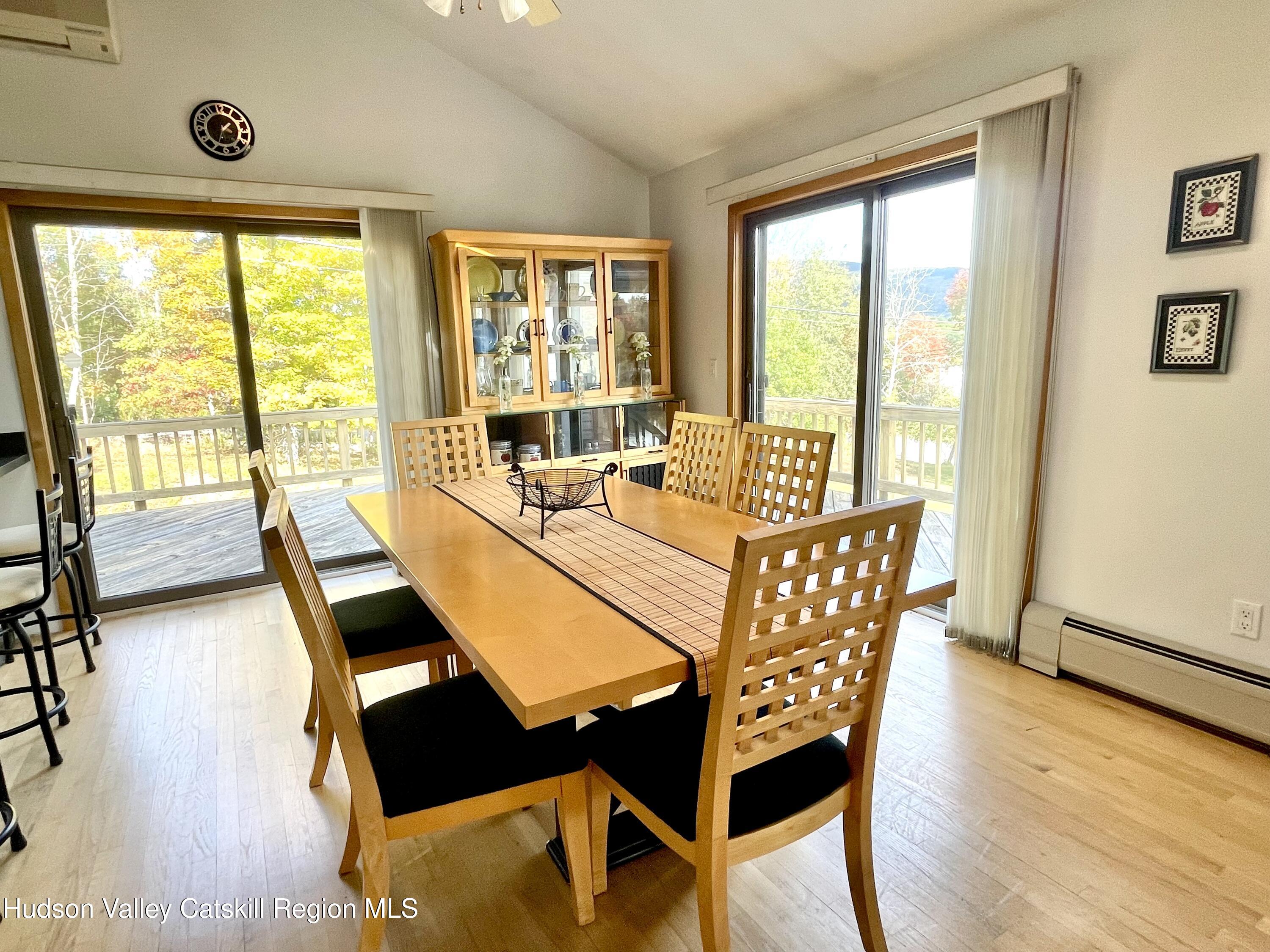 415 Old Road Windham, NY 12496 - Photo 11 of 32 a dining room with wooden floor a glass table and chairs