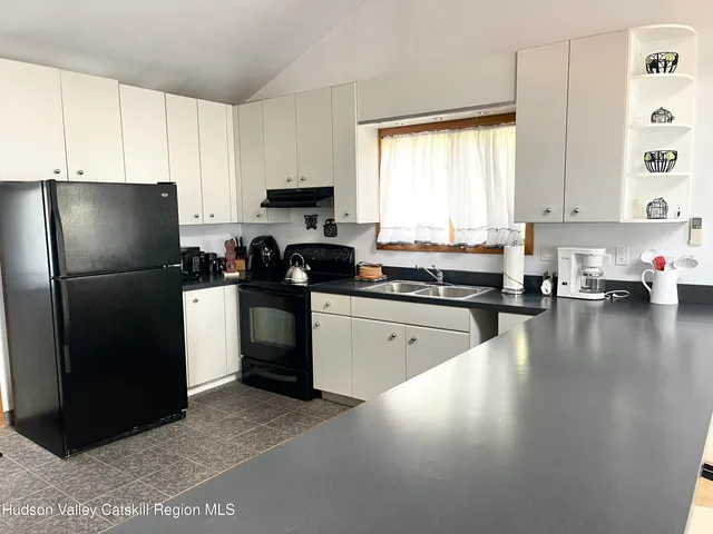 a large kitchen with stainless steel appliances granite countertop a sink and cabinets