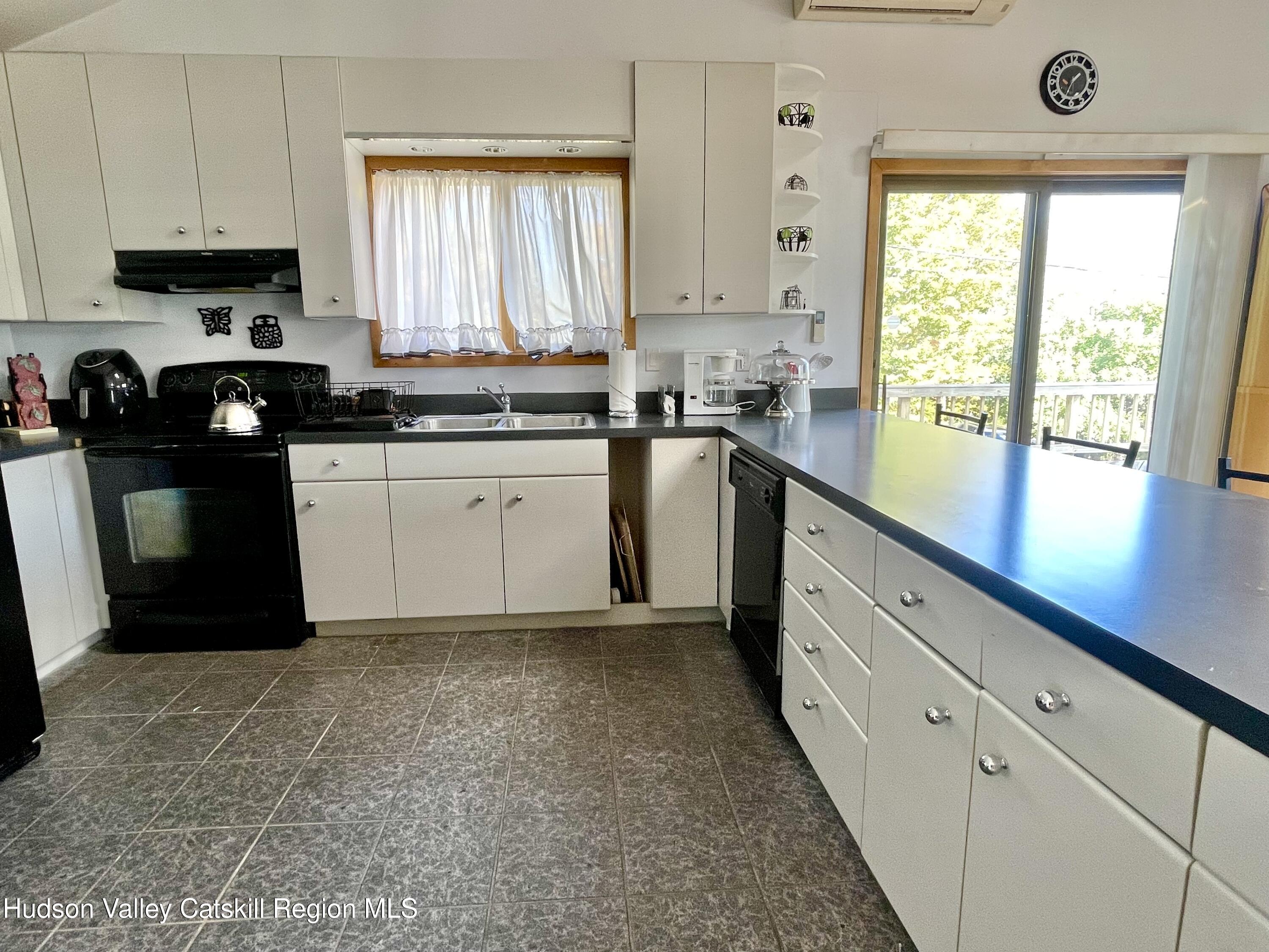 415 Old Road Windham, NY 12496 - Photo 14 of 32 a kitchen with granite countertop a stove a sink dishwasher and a refrigerator