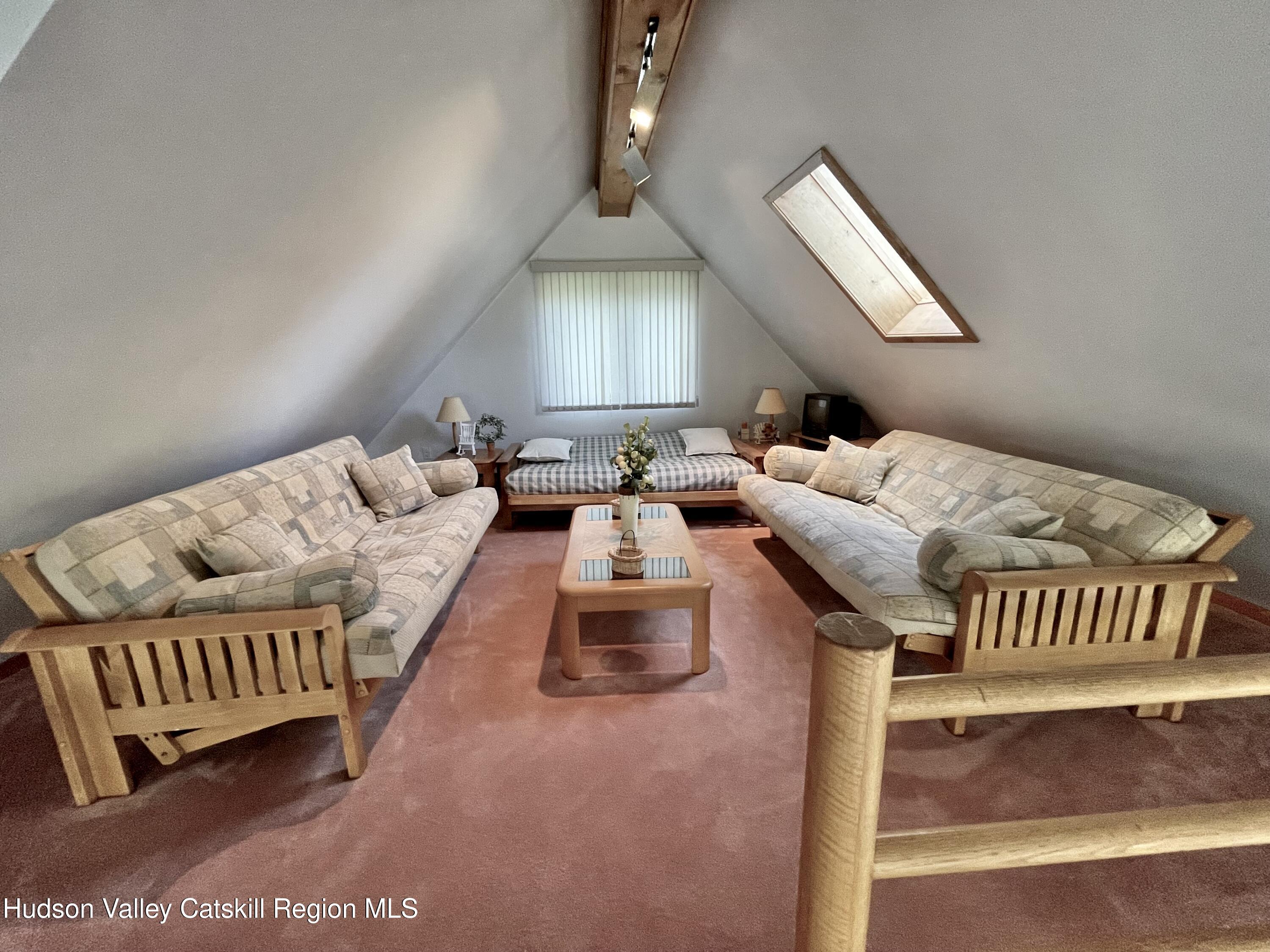 415 Old Road Windham, NY 12496 - Photo 20 of 32 a living room with furniture and a chandelier
