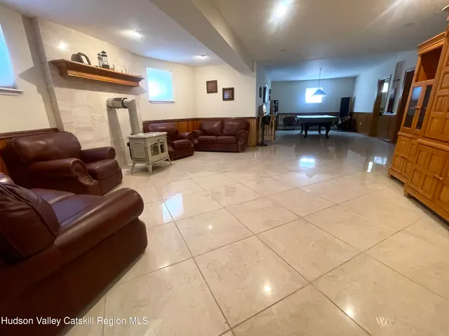 a room with pool table and windows