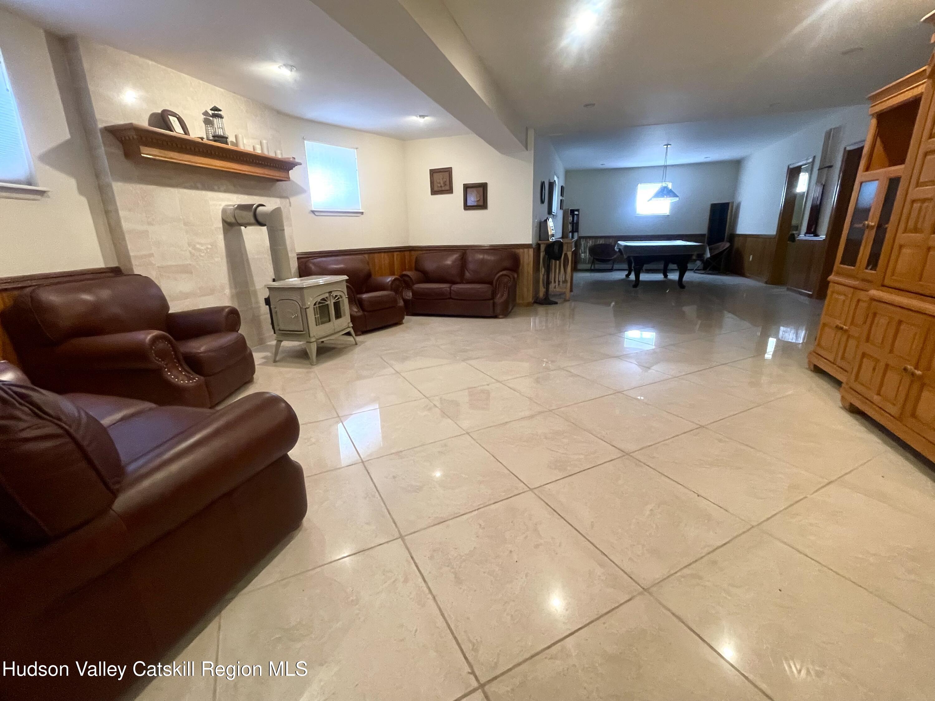 415 Old Road Windham, NY 12496 - Photo 25 of 32 a living room with furniture and a mirror