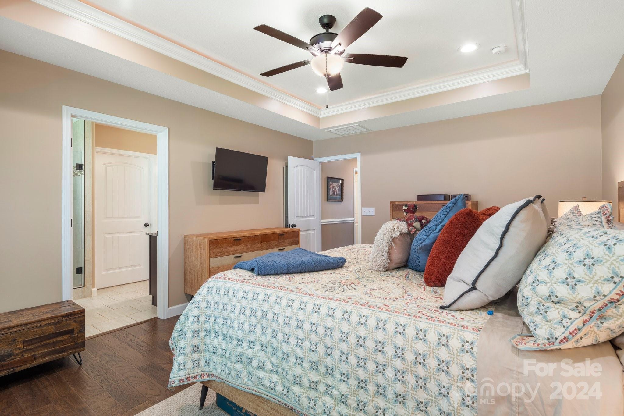262 Renard Road Tryon, NC 28782 - Photo 19 of 31 a bedroom with a bed and a flat screen tv