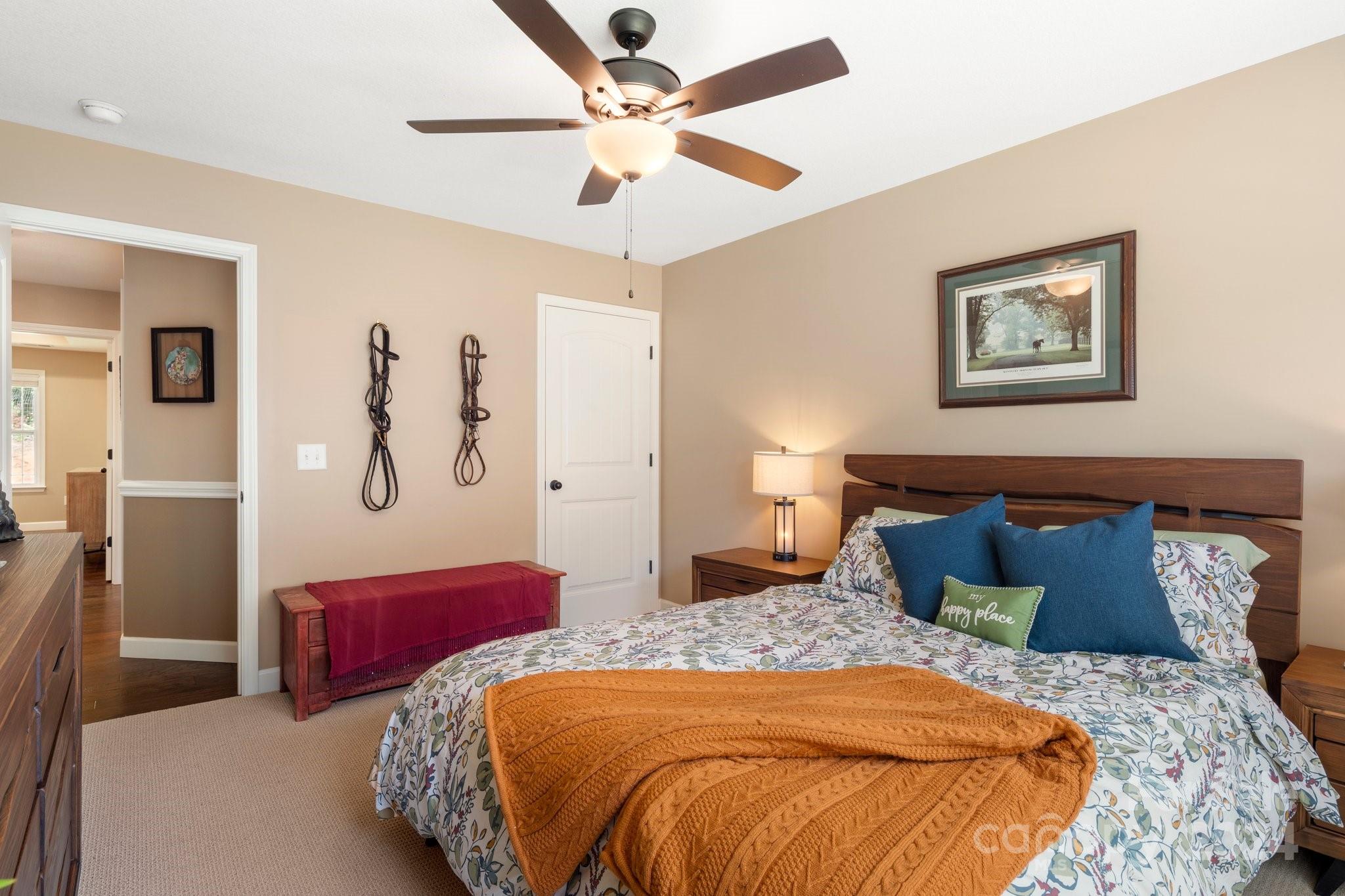 262 Renard Road Tryon, NC 28782 - Photo 23 of 31 a bedroom with a large bed and a chandelier