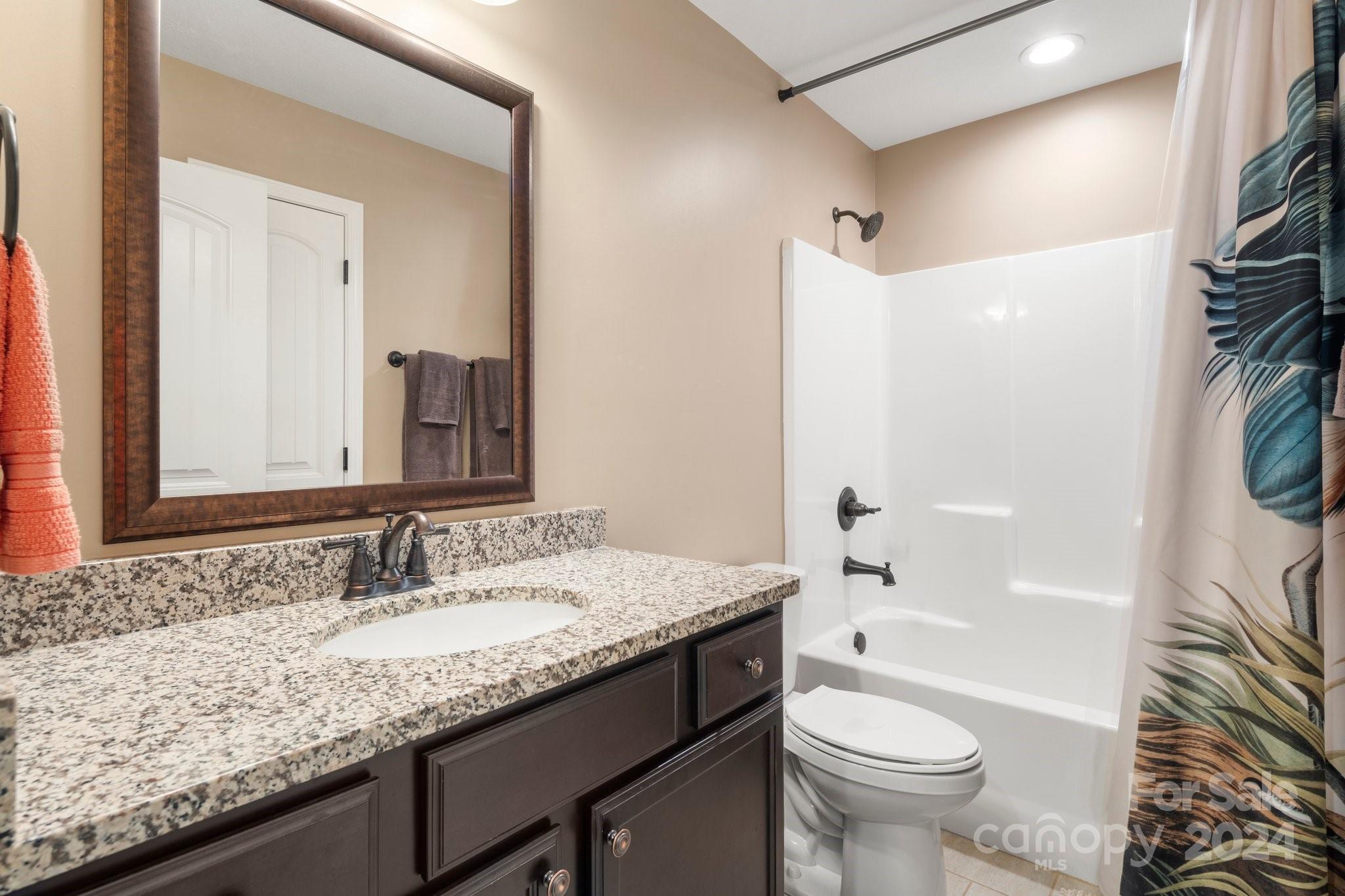 262 Renard Road Tryon, NC 28782 - Photo 26 of 31 a bathroom with a granite countertop sink toilet and shower