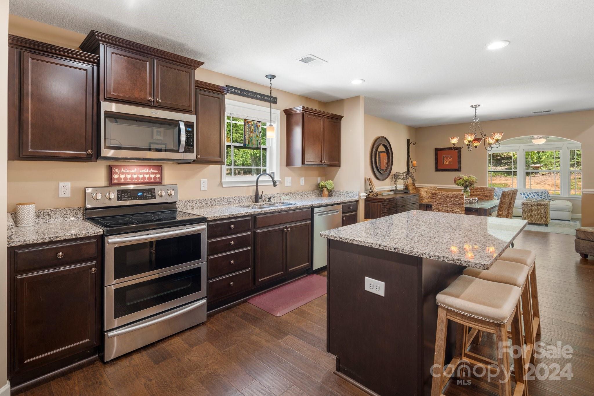 262 Renard Road Tryon, NC 28782 - Photo 10 of 31 a kitchen with stainless steel appliances granite countertop a stove a sink and a microwave