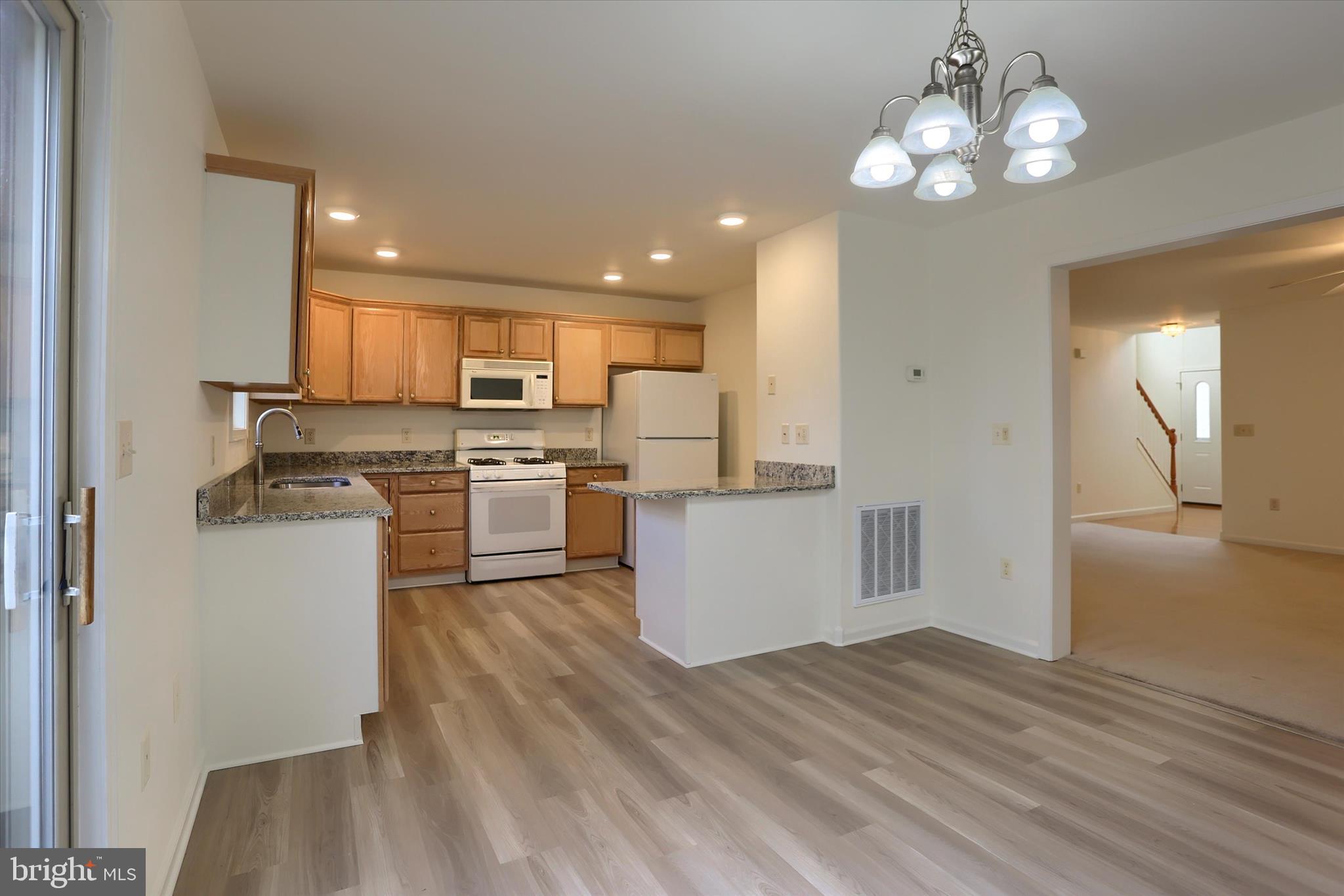 221 West Locust Street Enola, PA 17025 - Photo 12 of 46 a kitchen with a refrigerator a stove top oven a sink dishwasher and wooden cabinets