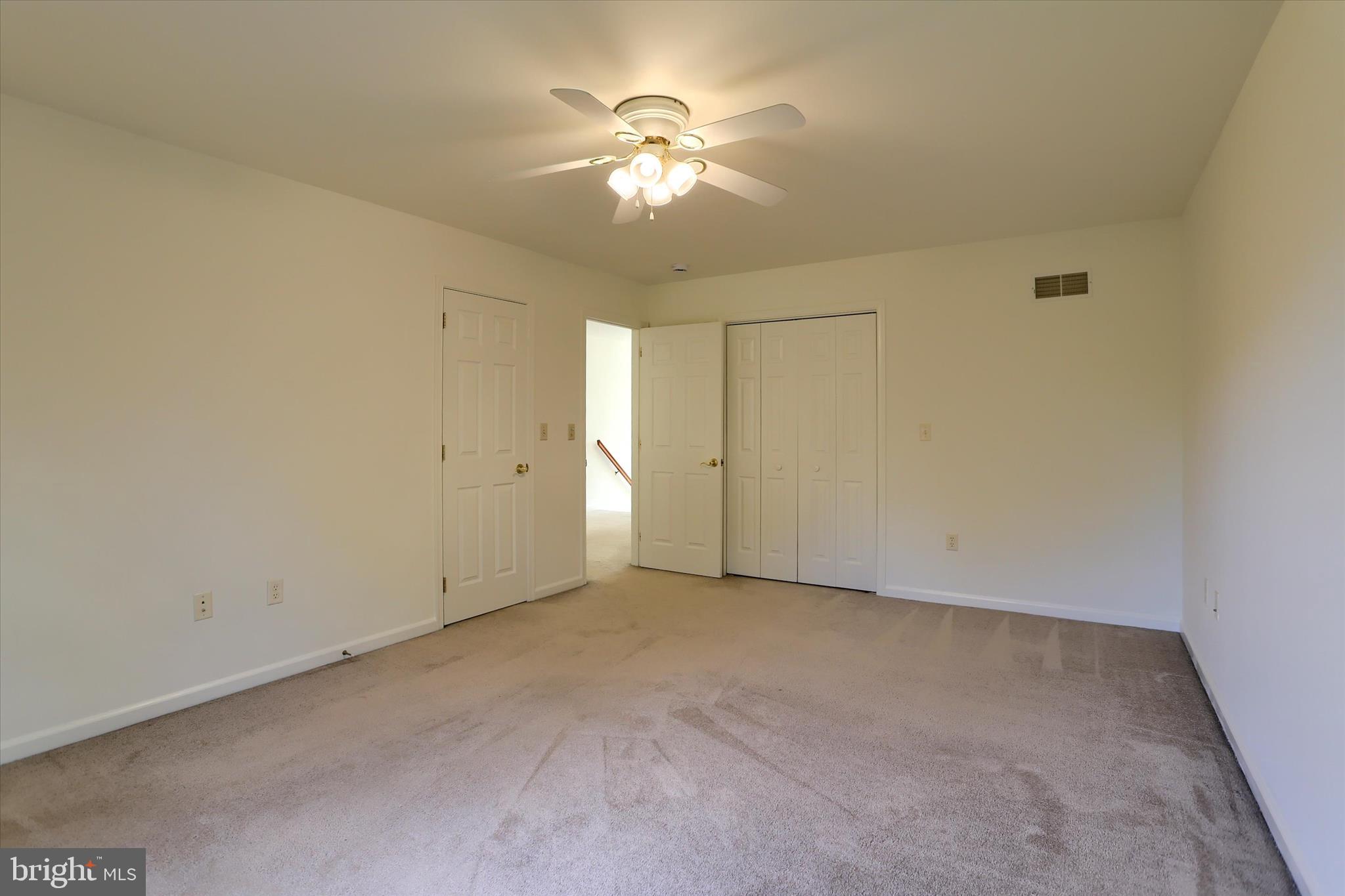 221 West Locust Street Enola, PA 17025 - Photo 30 of 46 an empty room with a chandelier fan and windows