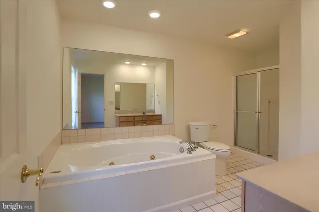 a bathroom with a bathtub sink and mirror