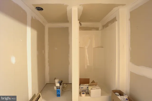 a view of a house with wooden fence